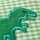 Applikation Dino auf grünem Stoff